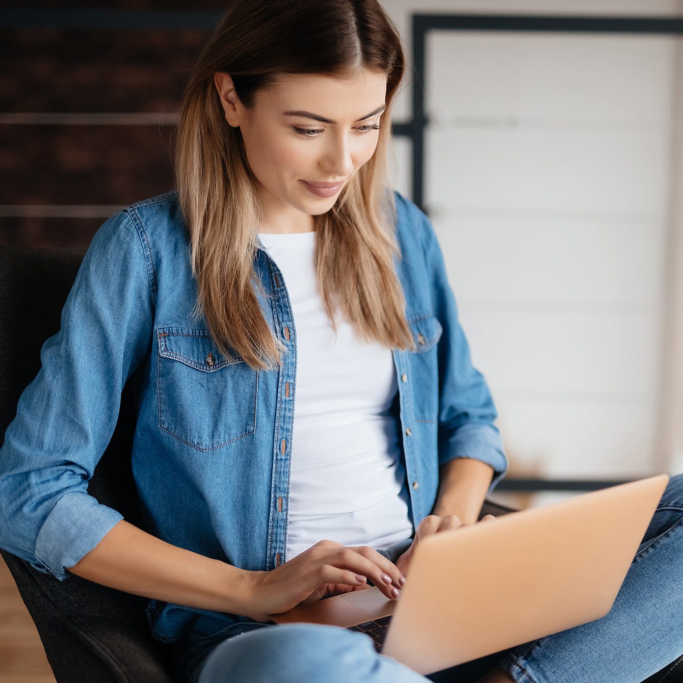 Millenial woman working on her laptop at home